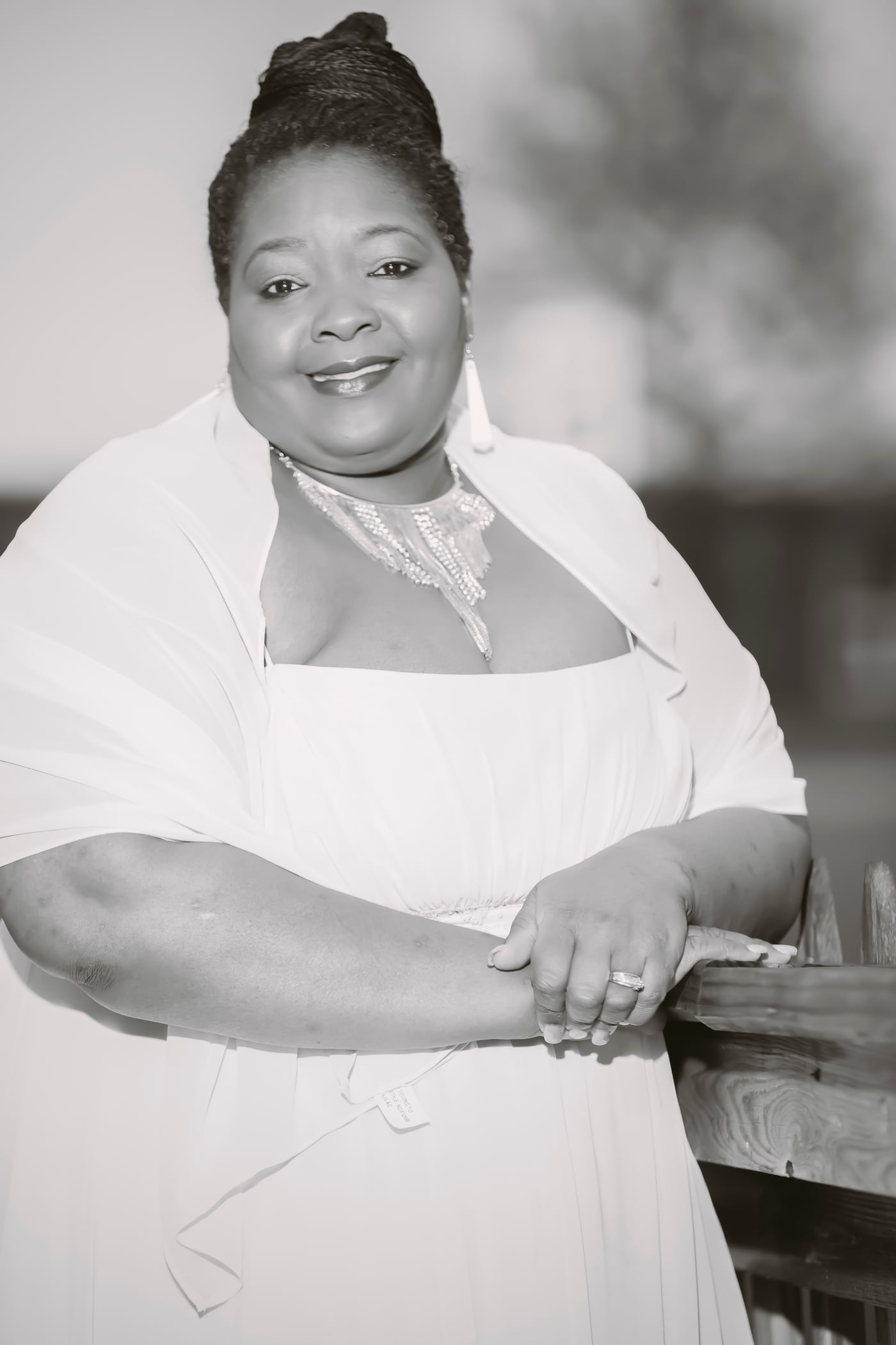 Woman in apron, warm smile, small-business owner. Photograph by Samuel Mfinanga for Mfinanga Photography + Motion.