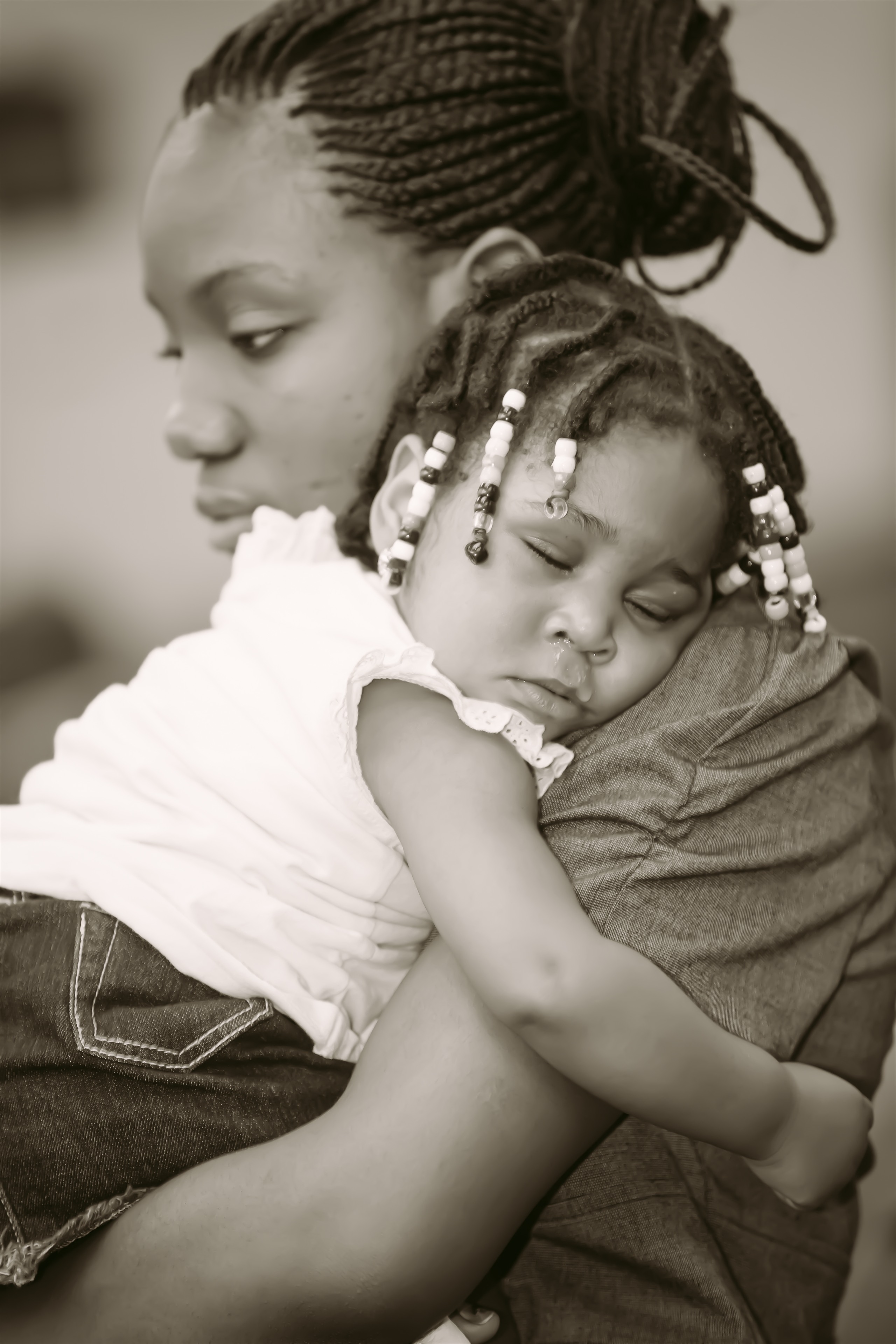 Mother and baby black-and-white portrait. Photograph by Samuel Mfinanga for Mfinanga Photography + Motion.