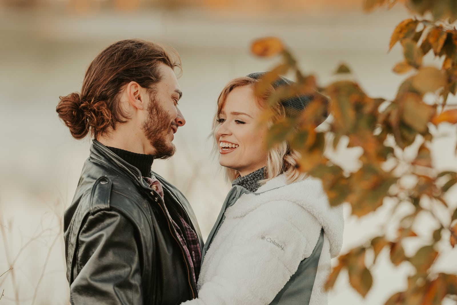Couple face-to-face laughing, autumn golden, engagement hero. Photograph by Samuel Mfinanga for Mfinanga Photography + Motion.