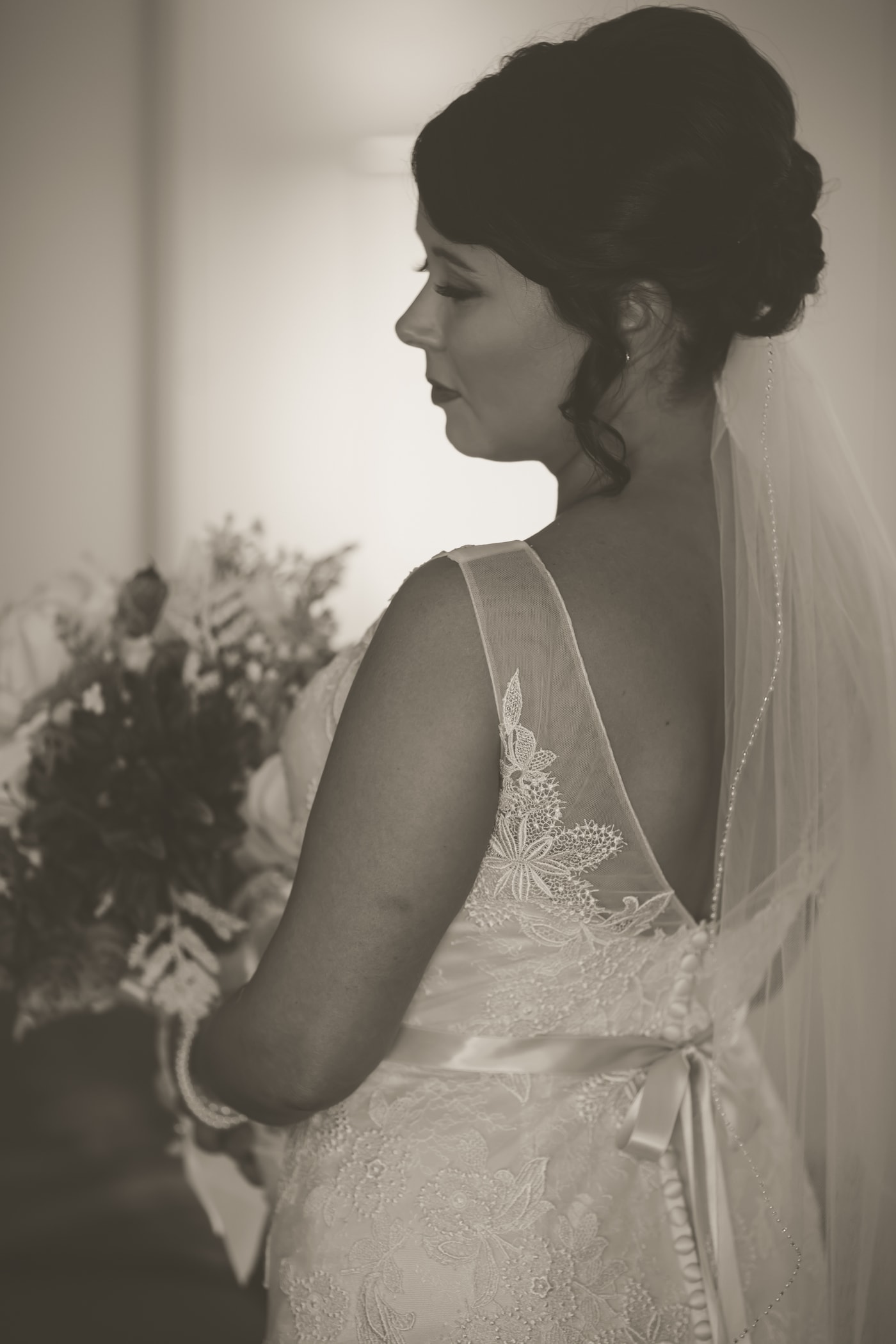 Bride profile with veil and window light. Photograph by Samuel Mfinanga for Mfinanga Photography + Motion.